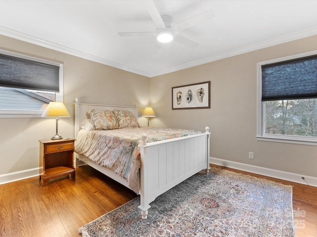 bedroom with crown molding, wood-type flooring, and ceiling fan