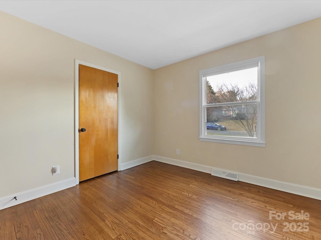 spare room featuring hardwood / wood-style flooring