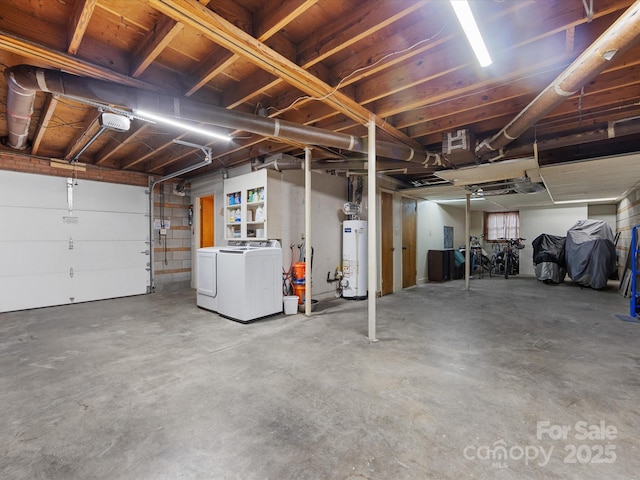 garage featuring gas water heater and washing machine and dryer