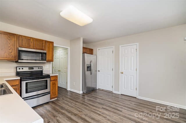 kitchen featuring sink, dark wood-type flooring, and appliances with stainless steel finishes