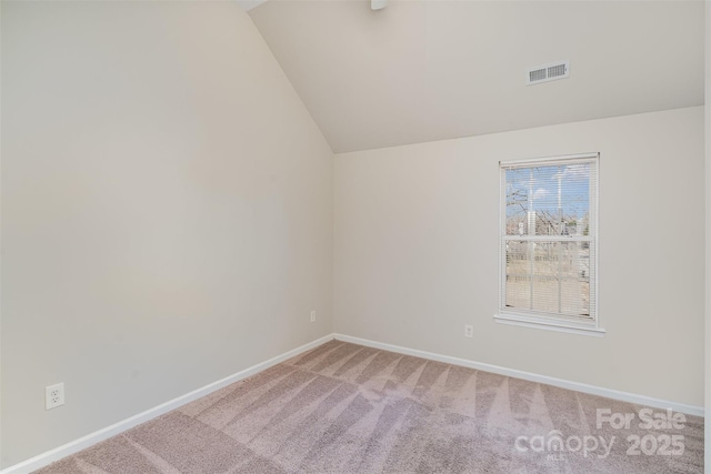 unfurnished room featuring vaulted ceiling and carpet