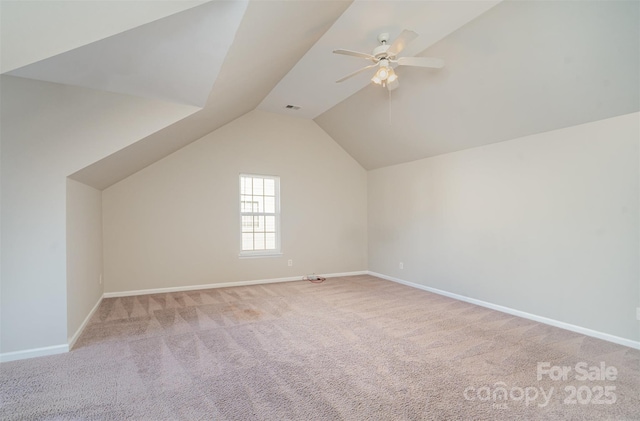 additional living space featuring light carpet, lofted ceiling, and ceiling fan