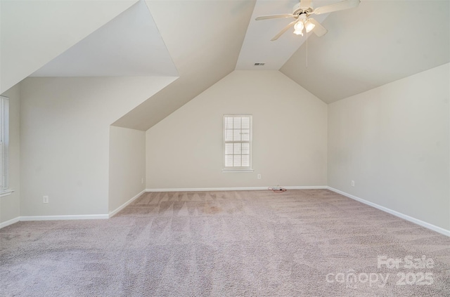 bonus room with ceiling fan, vaulted ceiling, and light carpet