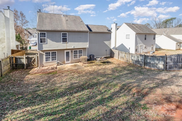 back of property with central AC, a yard, and a patio