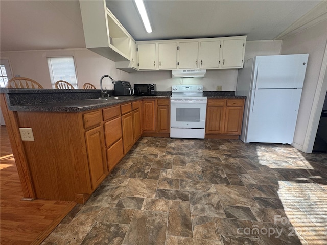 kitchen featuring sink, white appliances, and kitchen peninsula