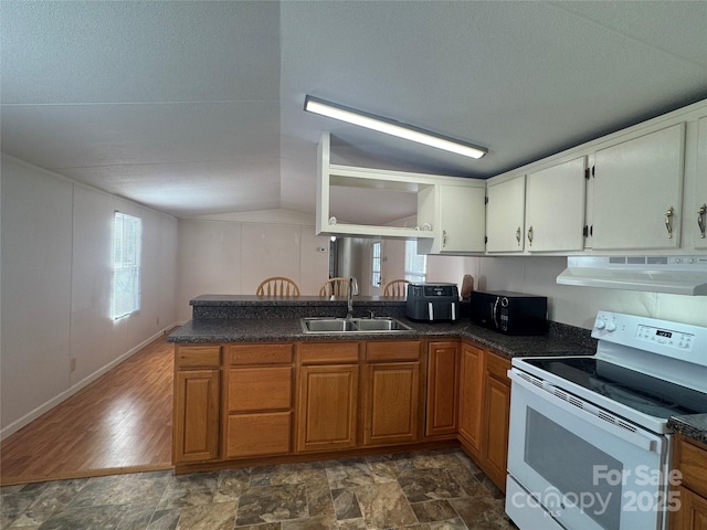 kitchen featuring lofted ceiling, sink, white electric stove, and kitchen peninsula