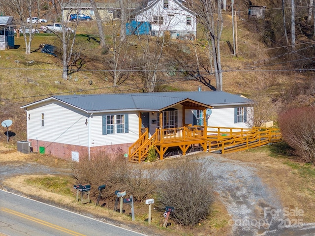 view of front of property featuring a wooden deck and central air condition unit