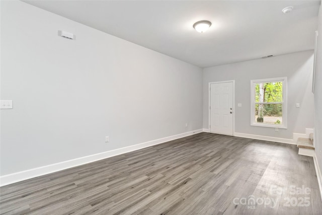 unfurnished room featuring hardwood / wood-style flooring