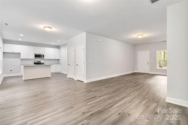 unfurnished living room with light wood-type flooring