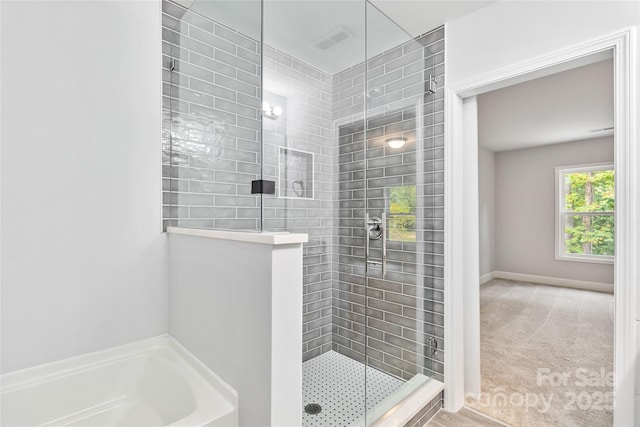 bathroom featuring shower with separate bathtub