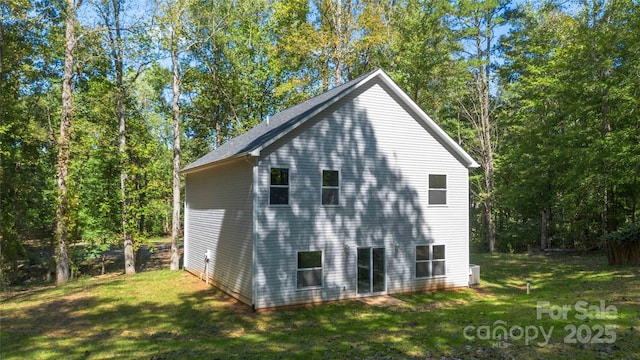 view of side of home with a yard