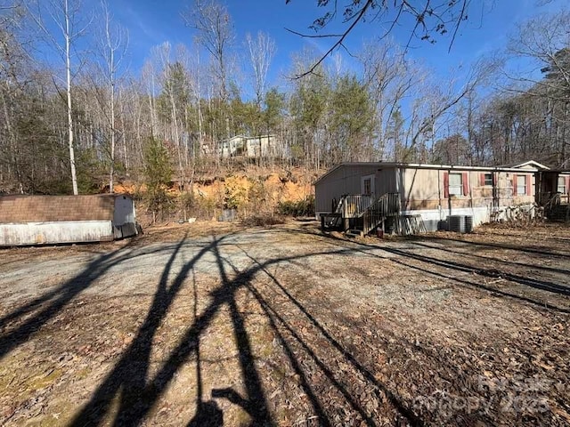 view of yard featuring central air condition unit