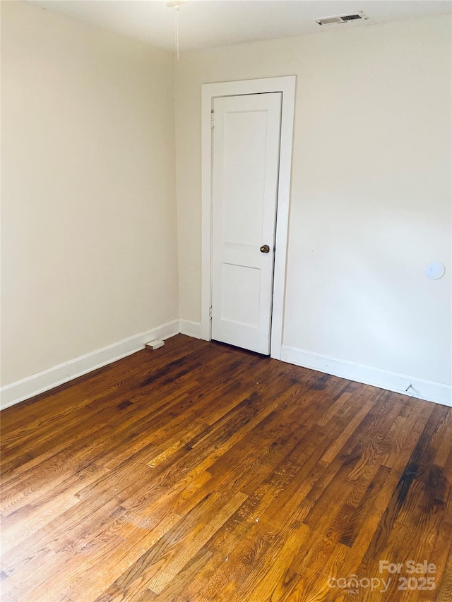 empty room with hardwood / wood-style flooring