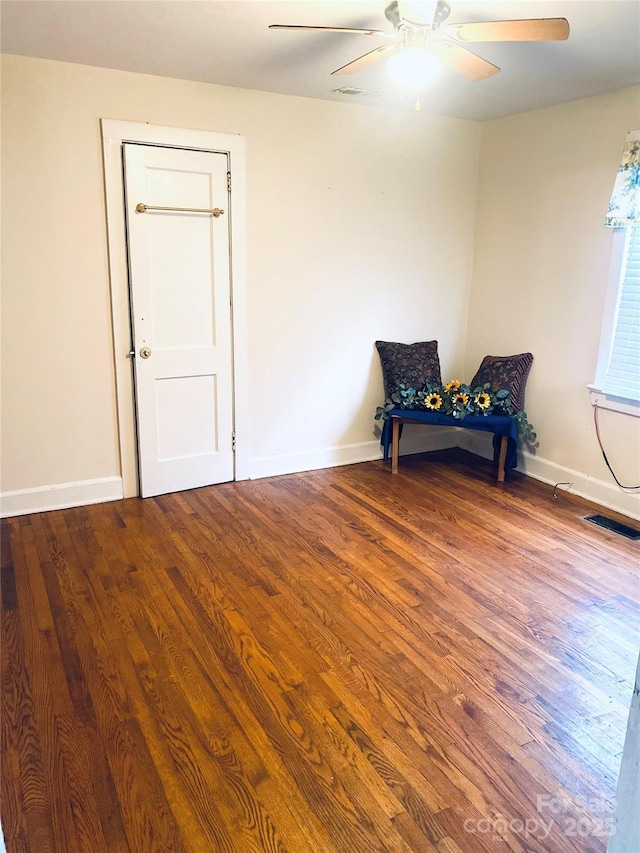 sitting room featuring ceiling fan and hardwood / wood-style floors