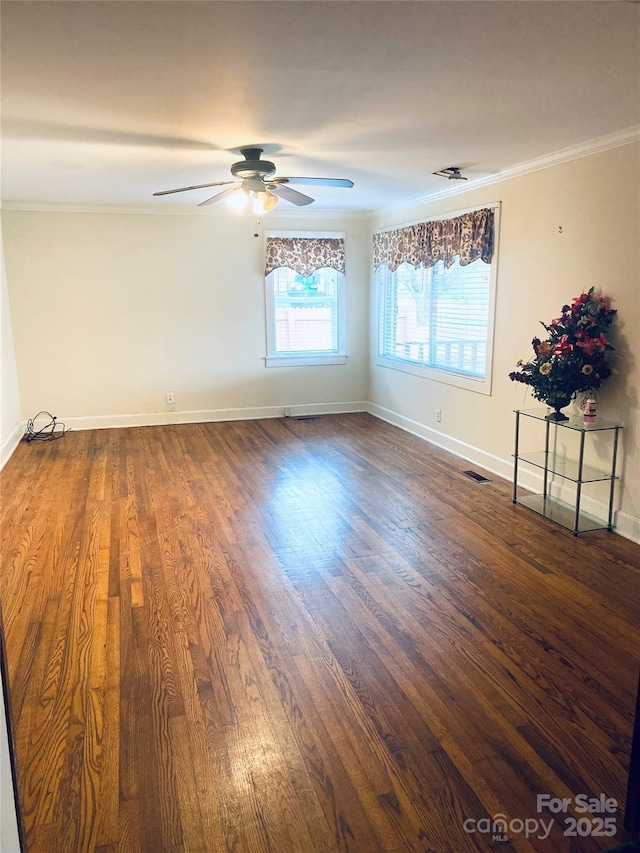 spare room featuring crown molding, dark hardwood / wood-style floors, and ceiling fan