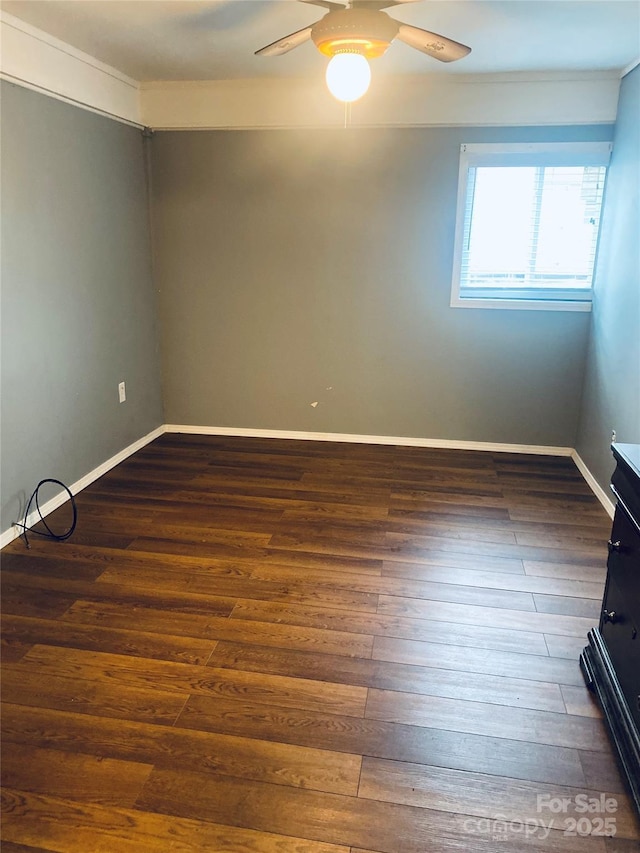 empty room with dark wood-type flooring and ceiling fan