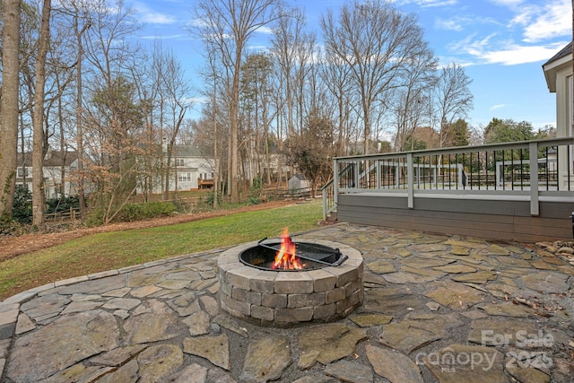 view of patio / terrace featuring a deck and a fire pit