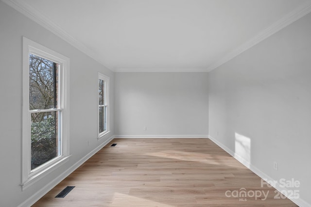 unfurnished room featuring ornamental molding and light hardwood / wood-style floors