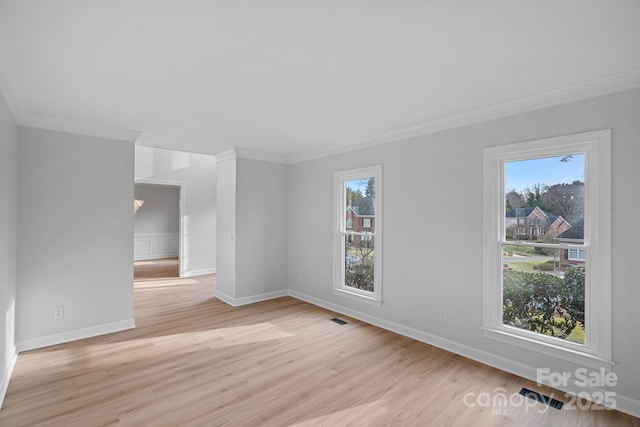 spare room with crown molding and light hardwood / wood-style floors