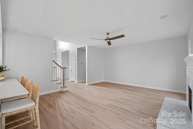 interior space with ceiling fan and light hardwood / wood-style floors