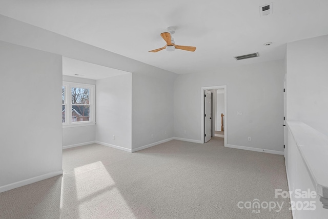 carpeted spare room with ceiling fan