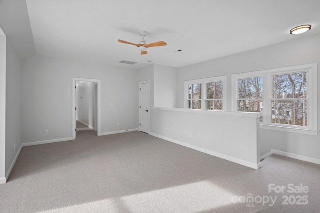 carpeted spare room with ceiling fan