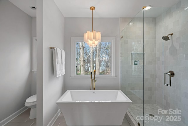 bathroom with tile patterned floors, plus walk in shower, and toilet