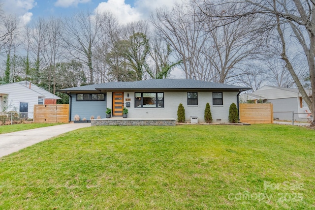 view of front of house with brick siding, crawl space, a front yard, and fence