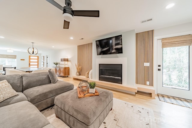 living room featuring light wood-style floors, a wealth of natural light, and recessed lighting