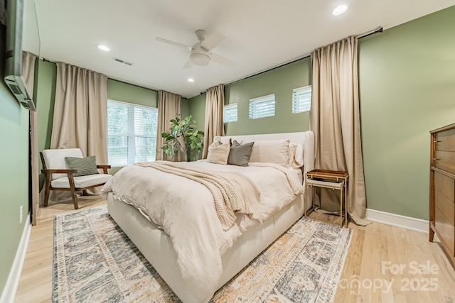 bedroom featuring light wood finished floors, baseboards, visible vents, and recessed lighting