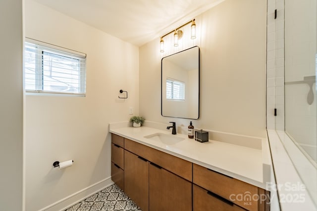 bathroom with plenty of natural light, baseboards, and vanity