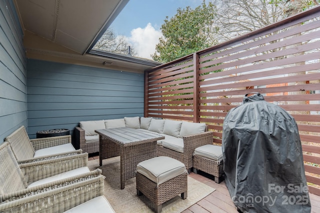 deck with outdoor lounge area and a grill