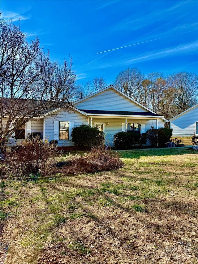 view of side of property with a yard