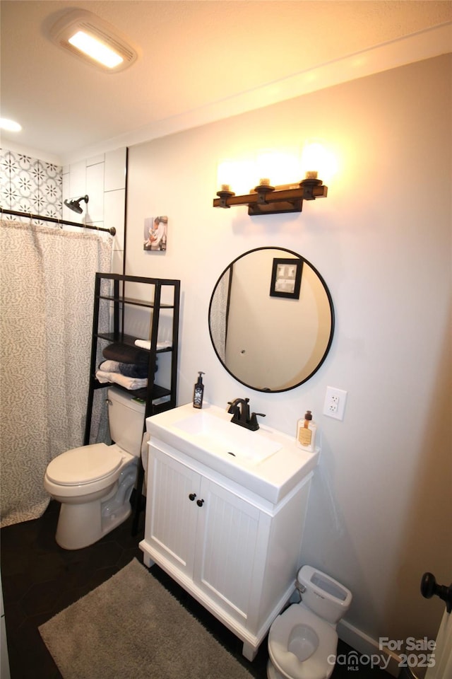 bathroom with toilet, vanity, and a shower with shower curtain