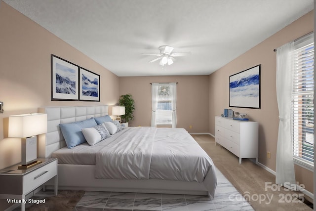 bedroom with a ceiling fan and baseboards