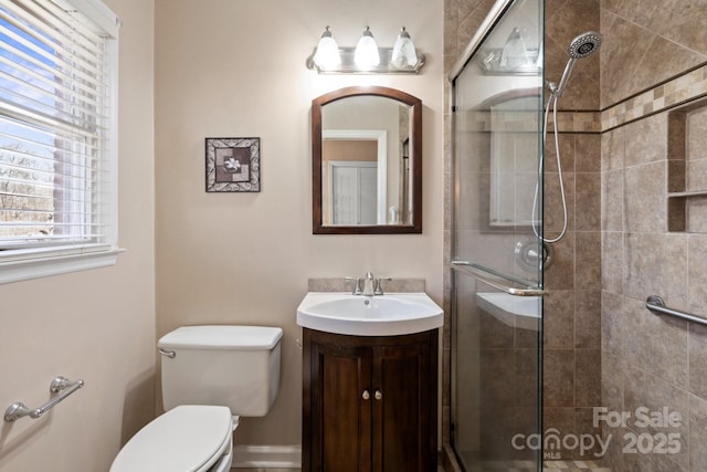 full bath with toilet, tiled shower, and vanity