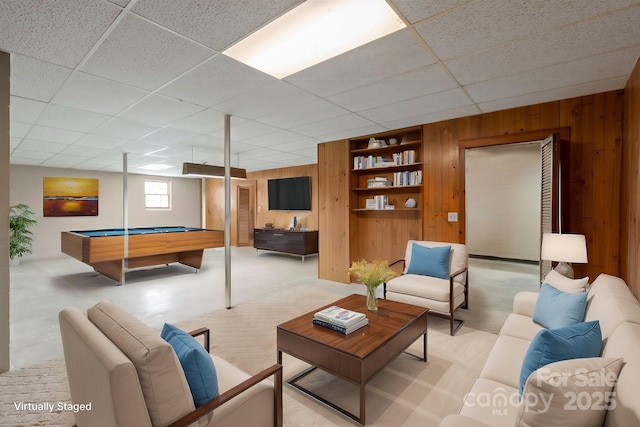 game room featuring built in shelves, a paneled ceiling, pool table, light carpet, and wood walls