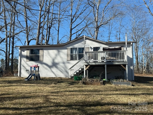 back of house with a yard and a deck