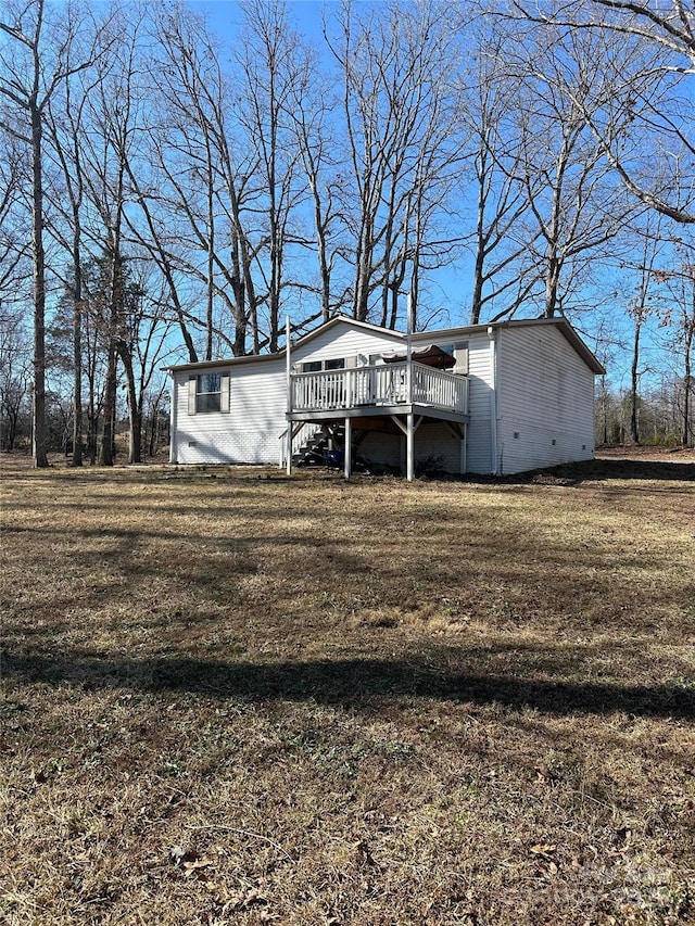 exterior space with a wooden deck and a lawn