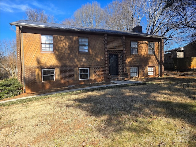 raised ranch featuring a front yard