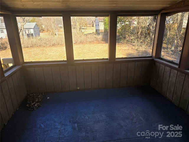 unfurnished sunroom with plenty of natural light and wooden ceiling