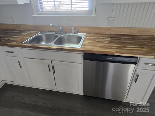 kitchen with butcher block countertops, sink, dark wood-type flooring, white cabinetry, and stainless steel dishwasher