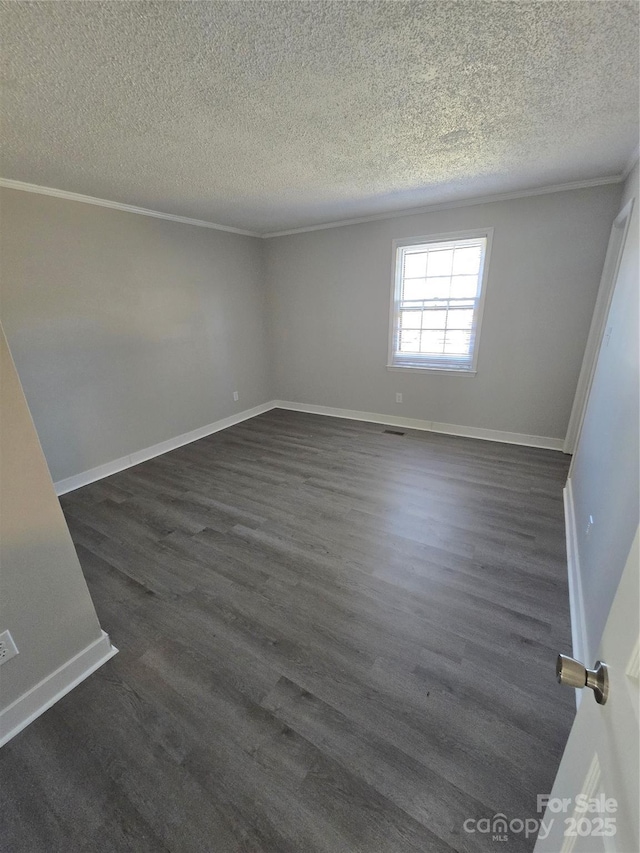 unfurnished room with crown molding, dark wood-type flooring, and a textured ceiling