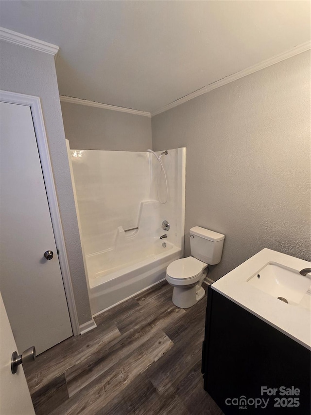 full bathroom with toilet, bathtub / shower combination, wood-type flooring, ornamental molding, and vanity