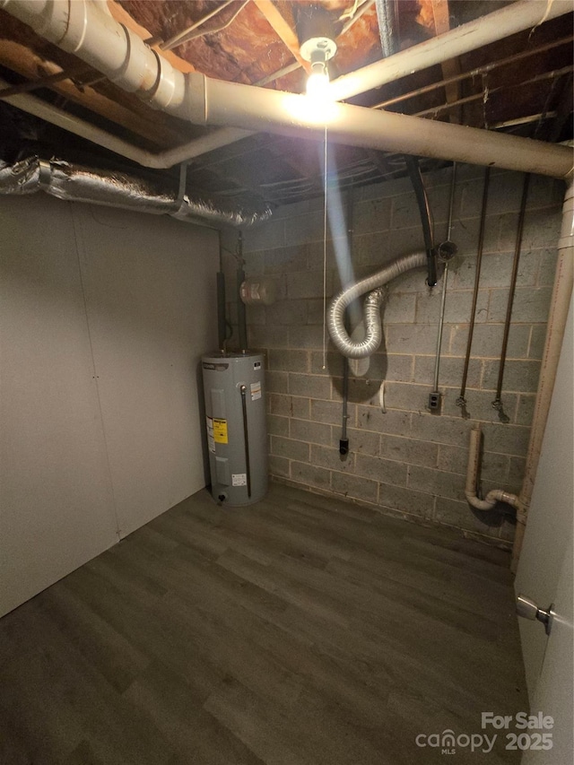 basement with dark hardwood / wood-style flooring and water heater