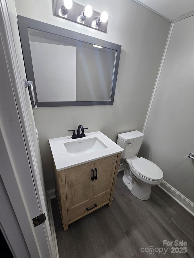 bathroom featuring hardwood / wood-style flooring, vanity, and toilet