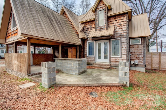 back of property with a patio and french doors