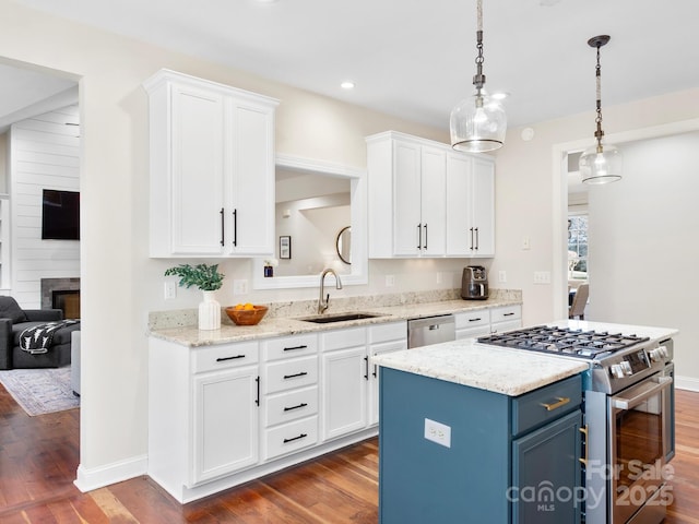 kitchen with white cabinetry, appliances with stainless steel finishes, sink, and dark hardwood / wood-style floors