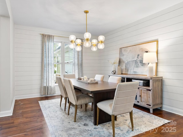 dining area featuring a notable chandelier and dark hardwood / wood-style flooring