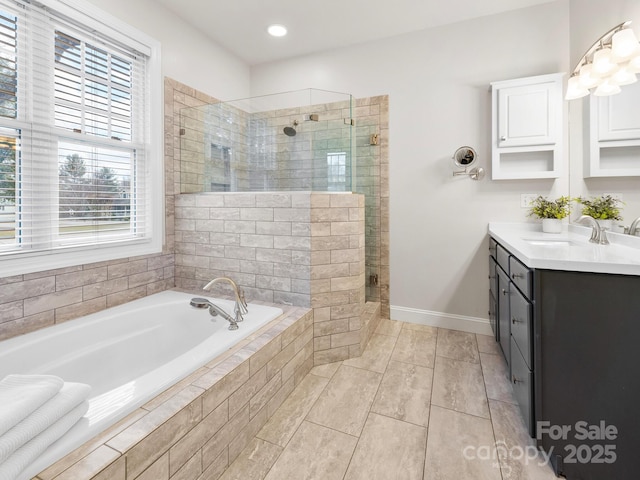 bathroom featuring independent shower and bath, vanity, and tile patterned floors